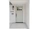 Inviting front door with sage-green finish, sleek black hardware, and brick surround at 3440 N Harrison St, Denver, CO 80205
