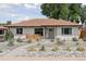 Charming single-story home boasts a well-manicured front yard with xeriscaping and lovely drought-tolerant plants at 3440 N Harrison St, Denver, CO 80205