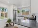 Bright kitchen features stainless steel appliances, light gray countertop, white cabinets and subway tile backsplash at 3440 N Harrison St, Denver, CO 80205