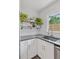 Bright kitchen features stainless steel sink, light gray countertop, white cabinets and subway tile backsplash at 3440 N Harrison St, Denver, CO 80205