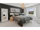Bedroom features a statement wall, natural light, soft carpet and modern overhead lighting at 3440 N Harrison St, Denver, CO 80205