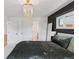 Bedroom features a statement wall, natural light, soft carpet and modern overhead lighting at 3440 N Harrison St, Denver, CO 80205