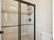 Bathroom showcasing glass enclosed tiled shower and toilet at 8621 S De Gaulle Ct, Aurora, CO 80016