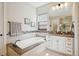 Well lit bathroom featuring soaking tub, walk in shower, and vanity at 8621 S De Gaulle Ct, Aurora, CO 80016