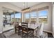 Sunlit dining area featuring a wooden table, stylish chairs, and sliding glass doors leading to outdoor space at 8621 S De Gaulle Ct, Aurora, CO 80016