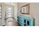 Stylish entryway featuring hardwood floors, an accent cabinet, and modern decor at 8621 S De Gaulle Ct, Aurora, CO 80016