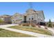 Charming two-story home with stone accents, manicured lawn, and a two-car garage at 8621 S De Gaulle Ct, Aurora, CO 80016