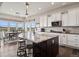 Well-lit kitchen featuring granite counters, stainless appliances, and dining area with scenic views at 8621 S De Gaulle Ct, Aurora, CO 80016
