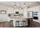 Bright kitchen with granite counters, stainless steel appliances and a breakfast bar with stylish pendant lighting at 8621 S De Gaulle Ct, Aurora, CO 80016