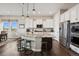 Modern kitchen featuring a granite island, stainless steel appliances, and a breakfast bar with stool seating at 8621 S De Gaulle Ct, Aurora, CO 80016
