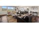 Bright living area featuring a comfortable seating arrangement and large windows offering a view of the landscape at 8621 S De Gaulle Ct, Aurora, CO 80016