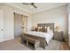 Cozy main bedroom with a sliding barn door, comfortable furnishings, and warm lighting from bedside lamps at 8621 S De Gaulle Ct, Aurora, CO 80016