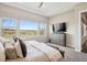 Peaceful main bedroom with ample natural light, a comfortable bed, and a dresser with mounted television at 8621 S De Gaulle Ct, Aurora, CO 80016
