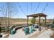 Inviting outdoor patio with a fire pit, pergola, string lights, and scenic views at 8621 S De Gaulle Ct, Aurora, CO 80016