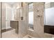 Stylish bathroom with marble tile, gray vanity, and a glass-enclosed walk-in shower at 1501 Wazee St # 4B, Denver, CO 80202