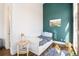 Cozy bedroom with a white daybed, accent wall, and hardwood floors, providing a tranquil retreat at 1501 Wazee St # 4B, Denver, CO 80202