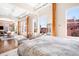 Bright bedroom with large windows and exposed wood beams overlooking a rooftop terrace at 1501 Wazee St # 4B, Denver, CO 80202