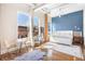 Bright bedroom with hardwood floors, exposed beam, and large windows allows for natural light at 1501 Wazee St # 4B, Denver, CO 80202