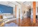 Spacious bedroom features a blue accent wall, hardwood floors, and modern lighting fixtures at 1501 Wazee St # 4B, Denver, CO 80202