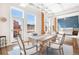 Bright dining room with large windows, a stylish chandelier, and views of the outdoor space at 1501 Wazee St # 4B, Denver, CO 80202