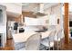 The stunning kitchen features an island with seating, white cabinets, and stainless steel appliances at 1501 Wazee St # 4B, Denver, CO 80202