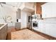 The kitchen features hardwood floors, stainless steel appliances, marble backsplash, and custom cabinets at 1501 Wazee St # 4B, Denver, CO 80202