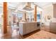 Modern kitchen island with stainless steel hood and a partial view of the dining area at 1501 Wazee St # 4B, Denver, CO 80202