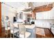 Spacious kitchen with an island, stainless steel appliances, exposed brick, and wooden floors at 1501 Wazee St # 4B, Denver, CO 80202