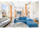 Bright living room with a plush sofa, large windows, wooden beams, and an open layout to the kitchen and dining area at 1501 Wazee St # 4B, Denver, CO 80202