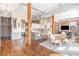 Bright open-concept living area with hardwood floors, exposed brick, and dining area is ideal for modern living at 1501 Wazee St # 4B, Denver, CO 80202