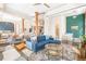Open-concept living area with exposed beams, a modern sofa, and views into the kitchen and bedroom at 1501 Wazee St # 4B, Denver, CO 80202