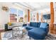 Spacious living room filled with natural light, featuring a comfortable sofa, wooden support beams, and city views at 1501 Wazee St # 4B, Denver, CO 80202