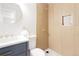 Modern bathroom with a shower featuring unique tile accents and gold fixtures at 7918 Raleigh Pl, Westminster, CO 80030