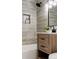 Bathroom showcasing textured tiles, a stylish vanity, and modern fixtures at 7918 Raleigh Pl, Westminster, CO 80030