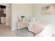 Cozy bedroom with a soft pink quilt and a stylish nightstand at 7918 Raleigh Pl, Westminster, CO 80030