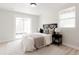Bedroom features a stylish headboard, luxurious bedding, and walk-out patio at 7918 Raleigh Pl, Westminster, CO 80030