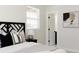 Bedroom features a stylish headboard, decorative pillows, and ensuite bathroom at 7918 Raleigh Pl, Westminster, CO 80030