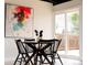 Cozy dining room features a round wooden table, four black chairs, and a sliding door to the outside at 7918 Raleigh Pl, Westminster, CO 80030