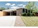 Inviting home with a carport, well-maintained lawn, and rock landscaping at 7918 Raleigh Pl, Westminster, CO 80030