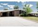 Charming home featuring a covered carport, a long driveway, and a green lawn at 7918 Raleigh Pl, Westminster, CO 80030