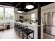 Bright kitchen with stainless steel appliances, breakfast bar, and modern lighting fixtures at 7918 Raleigh Pl, Westminster, CO 80030