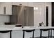 Modern kitchen with stainless steel appliances, white cabinets, and a large island with seating at 7918 Raleigh Pl, Westminster, CO 80030