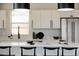 Modern white kitchen with sleek countertops, stainless steel appliances, and pendant lighting at 7918 Raleigh Pl, Westminster, CO 80030