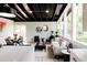 Open living room features black ceiling, abundant natural light, and contemporary decor at 7918 Raleigh Pl, Westminster, CO 80030