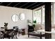 Open living area with black ceiling, modern furniture, and ample natural light from large windows at 7918 Raleigh Pl, Westminster, CO 80030
