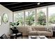 Inviting living area with modern furnishings, plants, large windows, and natural light at 7918 Raleigh Pl, Westminster, CO 80030