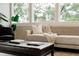 Inviting living room with large window views, comfortable seating, and stylish ottoman coffee table at 7918 Raleigh Pl, Westminster, CO 80030