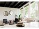 Bright living room with modern decor, black ceiling beams, and large windows with view at 7918 Raleigh Pl, Westminster, CO 80030