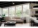 Bright, open living area featuring large windows, comfortable seating, and modern decor and kitchen at 7918 Raleigh Pl, Westminster, CO 80030