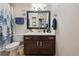 The bathroom has a mirror with a sink and a forest shower curtain at 5995 W Hampden Ave # 13G, Denver, CO 80227
